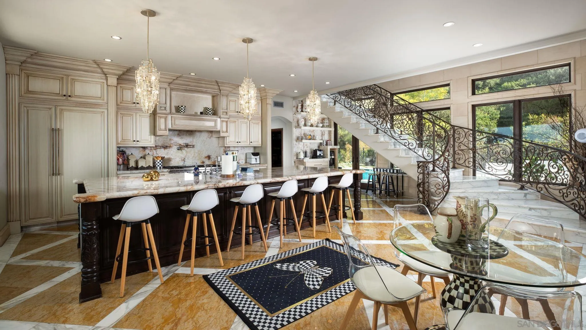 7853 Via Capri La Jolla, CA 92037 - Photo 32 of 67 a view of a dining room and livingroom with furniture wooden floor a chandelier