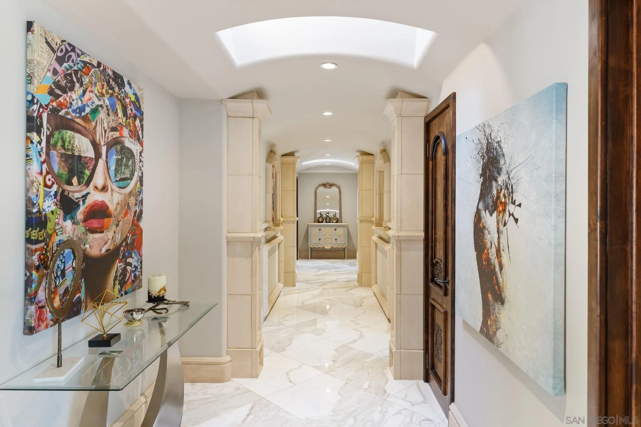 7853 Via Capri La Jolla, CA 92037 - Photo 37 of 67 a view of a hallway with wooden floor and windows