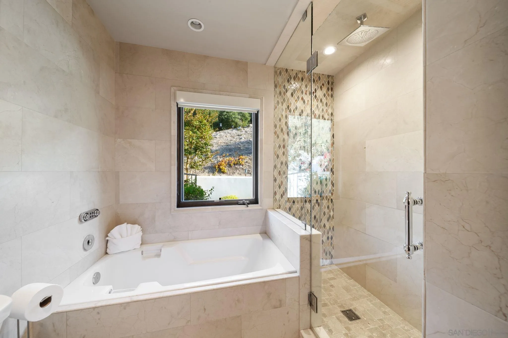 7853 Via Capri La Jolla, CA 92037 - Photo 42 of 67 a bathroom with a tub and shower