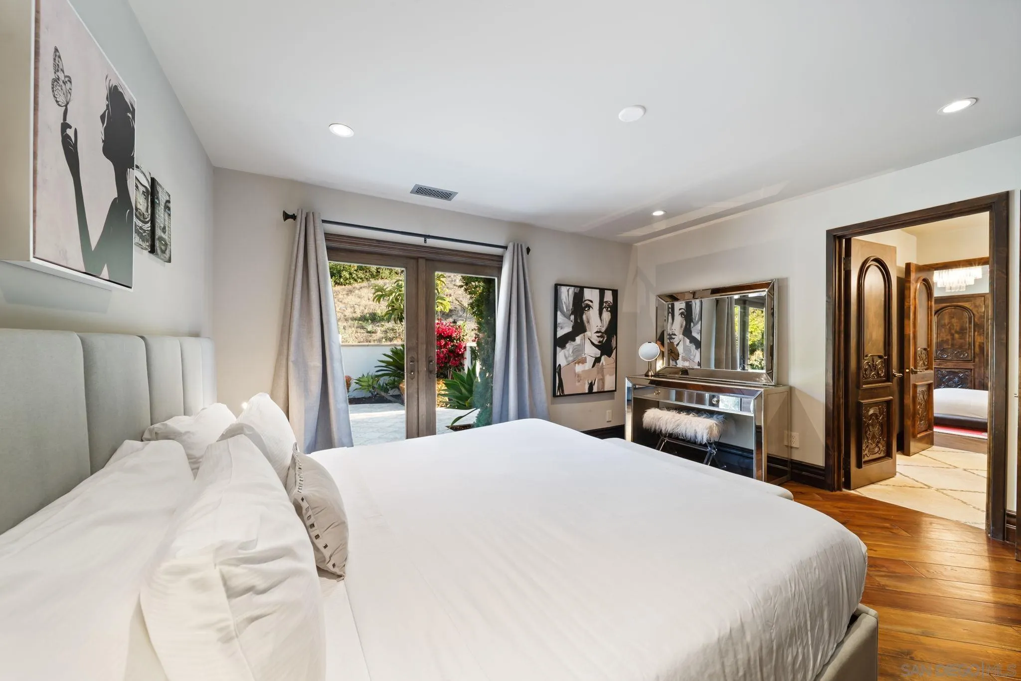 7853 Via Capri La Jolla, CA 92037 - Photo 44 of 67 a large bedroom with wooden floor and large window