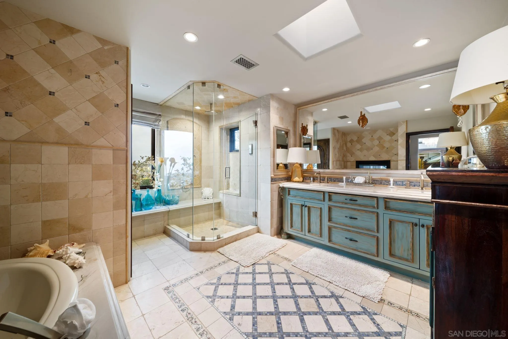 7853 Via Capri La Jolla, CA 92037 - Photo 48 of 67 a large bathroom with a sink mirror and shower