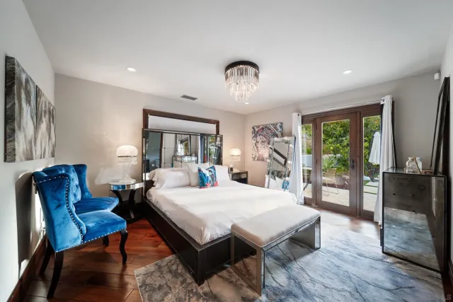 a kitchen with stainless steel appliances granite countertop a stove top oven a sink dishwasher and a dining table with garden view