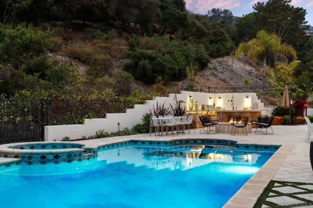a view of a patio with couches table and chairs and potted plants