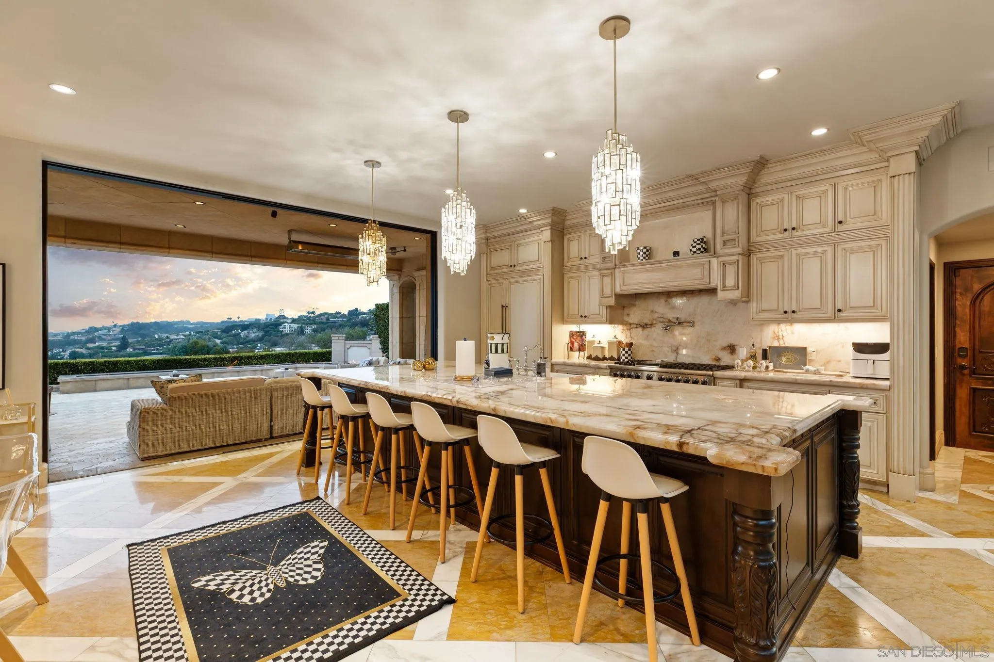7853 Via Capri La Jolla, CA 92037 - Photo 67 of 67 a kitchen with stainless steel appliances granite countertop a stove top oven a sink dishwasher and a dining table with garden view
