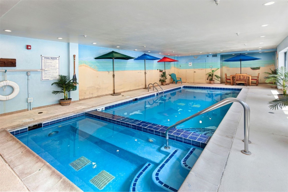 23110 Highway 6, Unit 5062 Keystone, CO 80435 - Photo 22 of 37 a kitchen with stainless steel appliances granite countertop a sink dishwasher and cabinets with wooden floor
