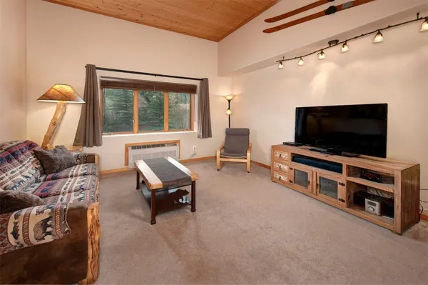 a view of a livingroom with furniture and a flat screen tv