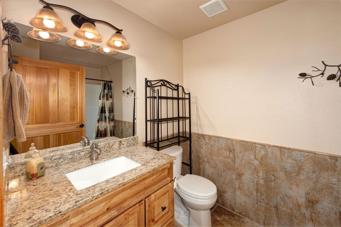 23110 Highway 6, Unit 5062 Keystone, CO 80435 - Photo 7 of 37 a bathroom with a granite countertop sink and a mirror