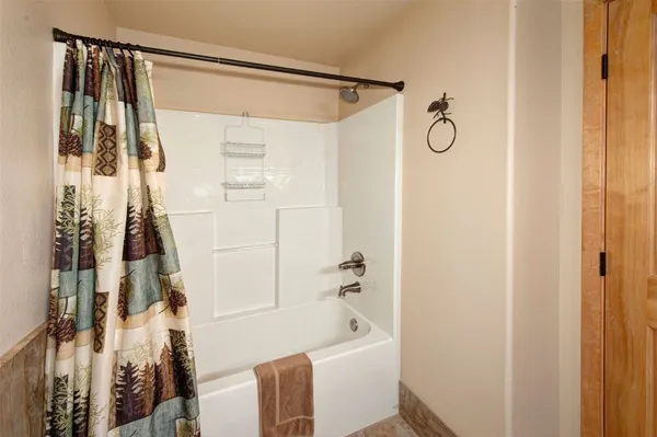 a bathroom with a shower and a tub