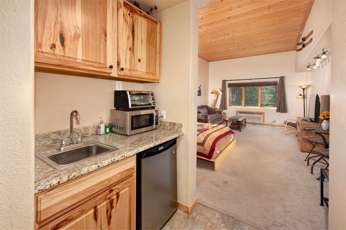 23110 Highway 6, Unit 5062 Keystone, CO 80435 - Photo 10 of 37 a kitchen with a sink stove and cabinets