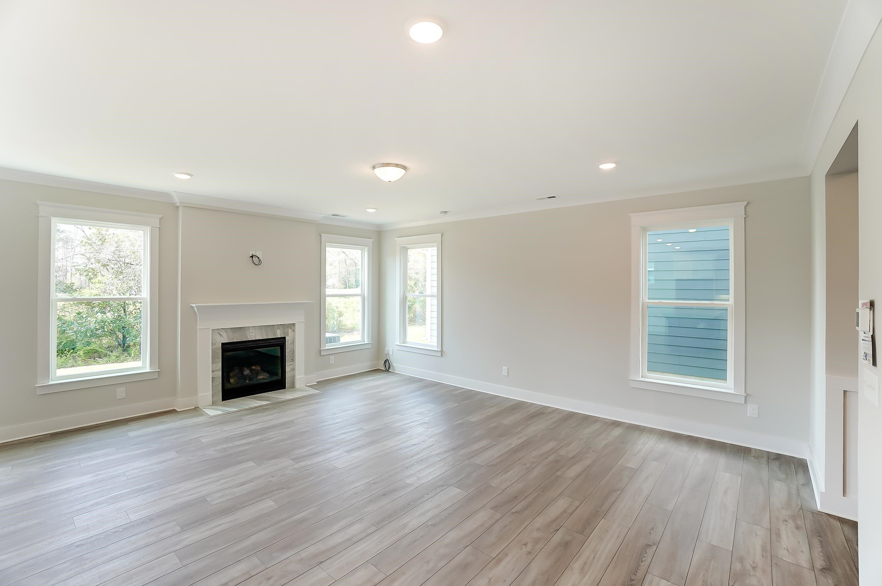 2109 Seneca Road Raleigh, NC 27604 - Photo 8 of 44 an empty room with windows and fireplace