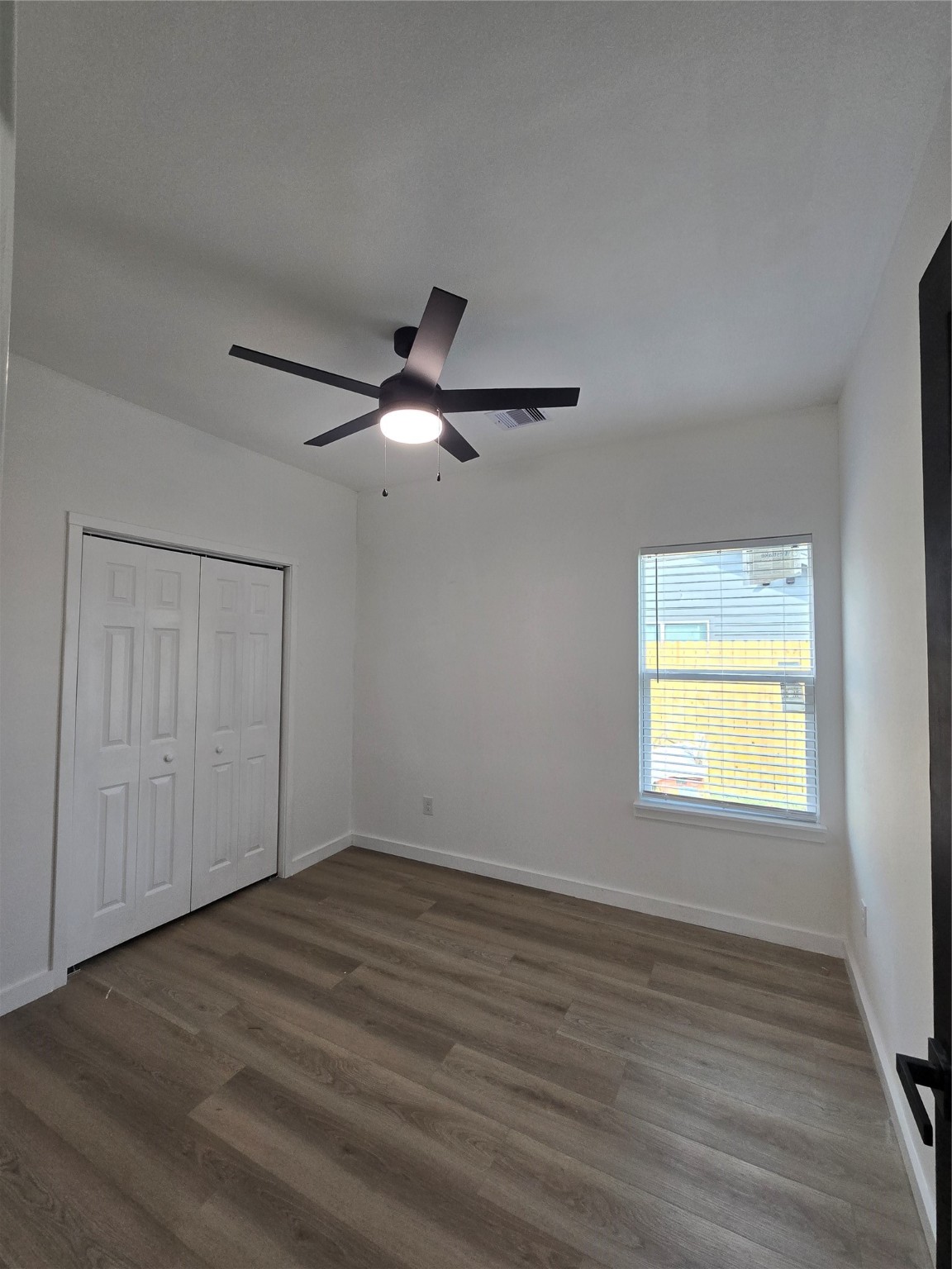 715 Rosedale Street La Marque, TX 77568 - Photo 11 of 14 wooden floor in an empty room with a window