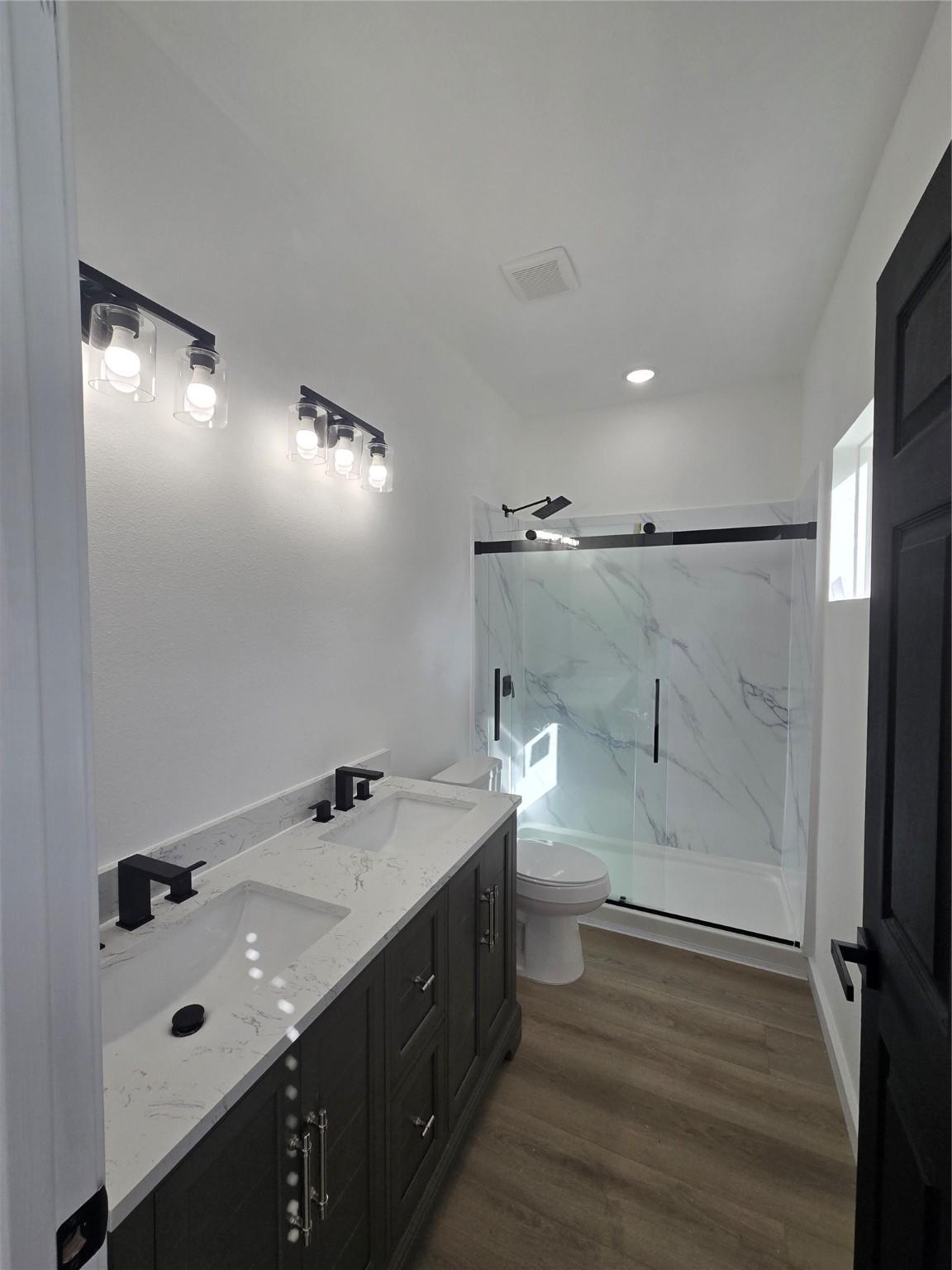 715 Rosedale Street La Marque, TX 77568 - Photo 13 of 14 a bathroom with a double vanity sink mirror and shower