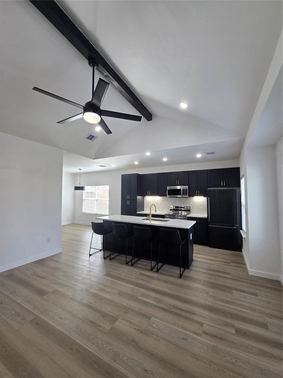 715 Rosedale Street La Marque, TX 77568 - Photo 2 of 14 a view of a big room with wooden floor a ceiling fan and windows