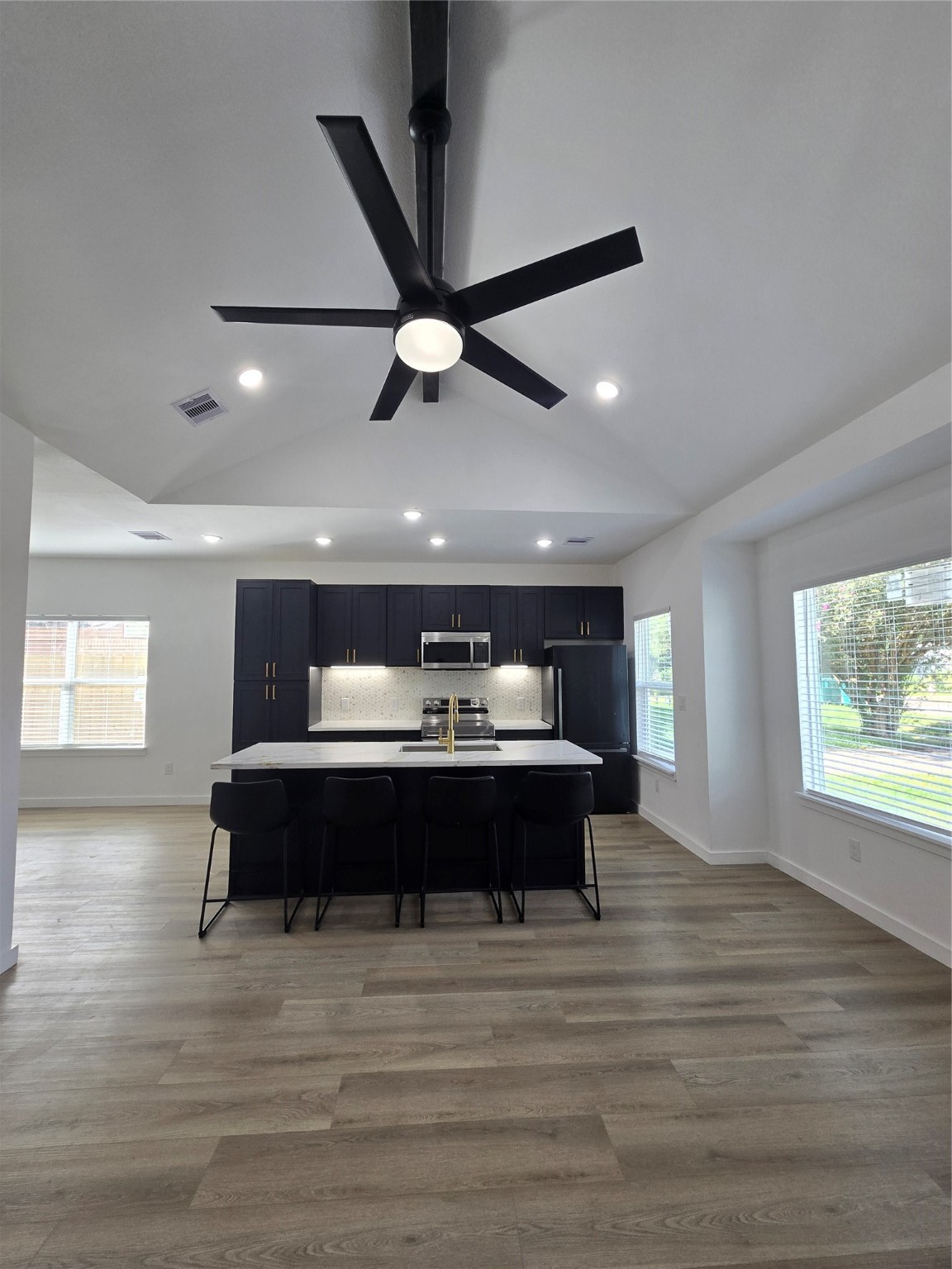 715 Rosedale Street La Marque, TX 77568 - Photo 3 of 14 a spacious bedroom with a bed and a chandelier