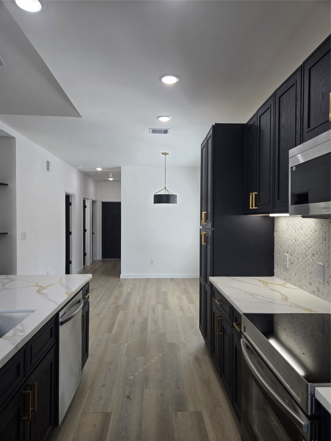 715 Rosedale Street La Marque, TX 77568 - Photo 7 of 14 a kitchen with stainless steel appliances a refrigerator and a stove