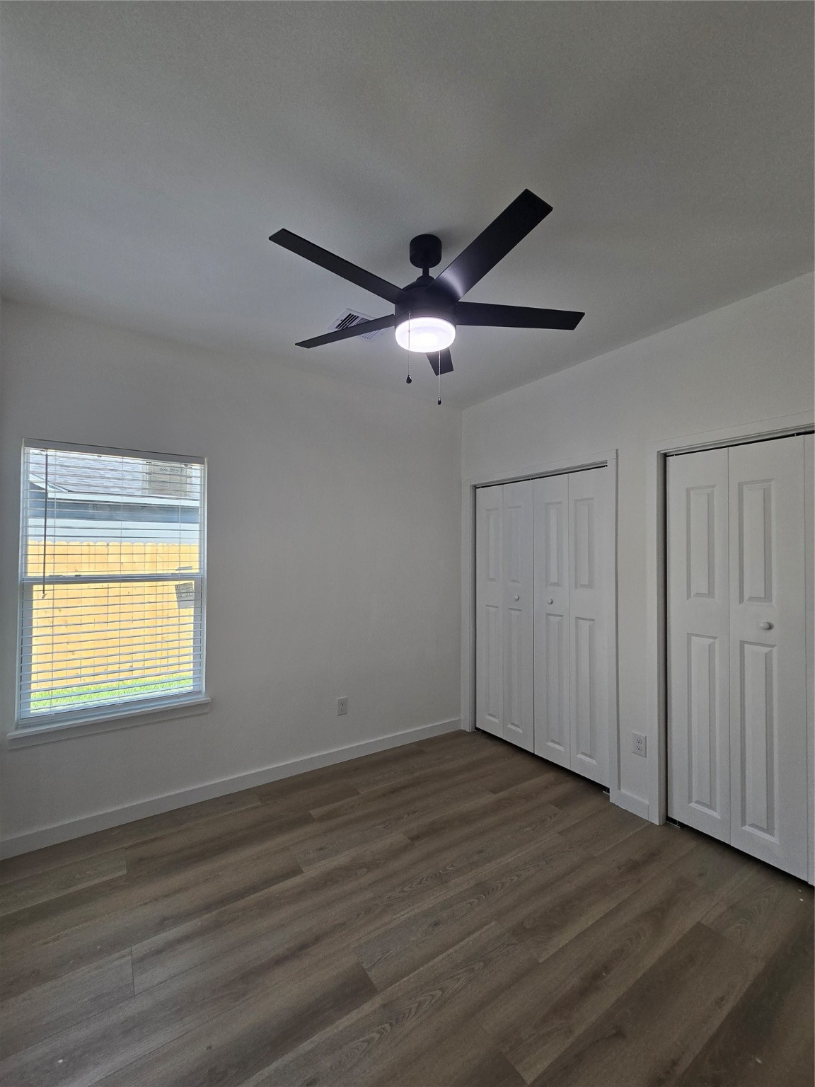 715 Rosedale Street La Marque, TX 77568 - Photo 10 of 14 a view of an empty room with wooden floor and a window