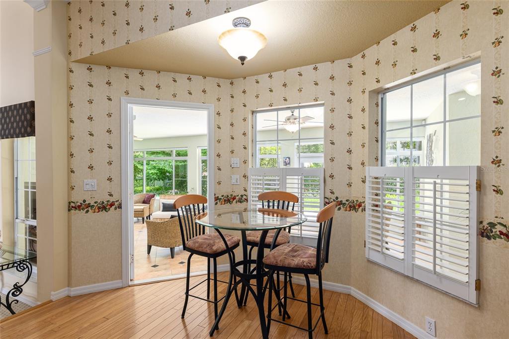 2215 Spring Hill Court Ocala, FL 34471 - Photo 21 of 62 a view of a dining room with furniture and wooden floor