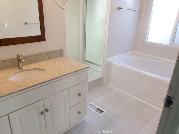 a bathroom with a sink a toilet and a window