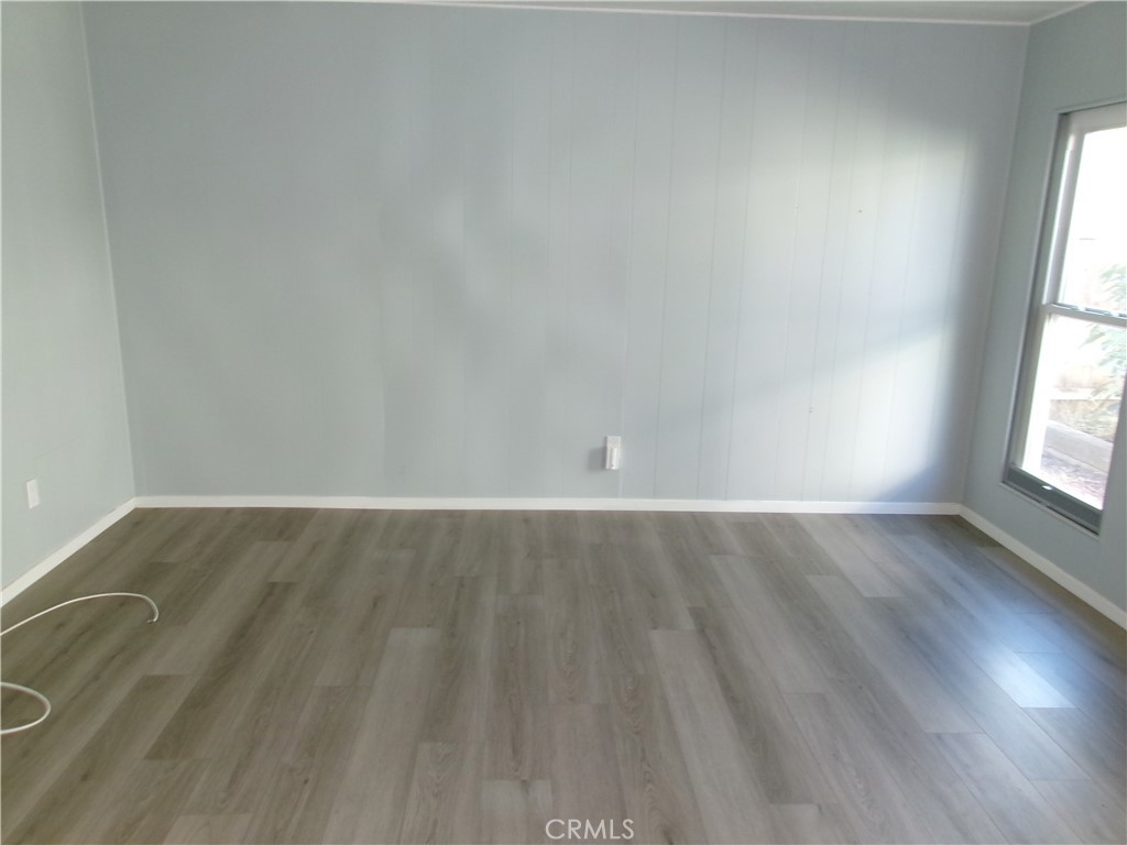 4044 Cherry Hill Road Santa Maria, CA 93455 - Photo 10 of 13 an empty room with wooden floor and windows