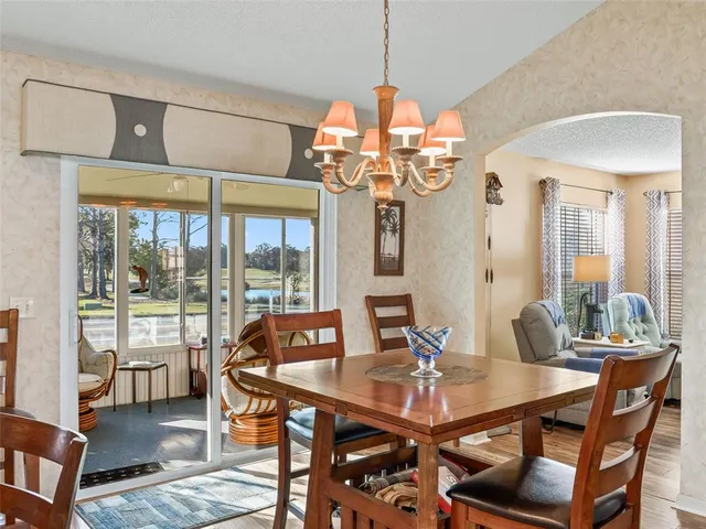 a view of a dining room with furniture wooden floor and chandelier