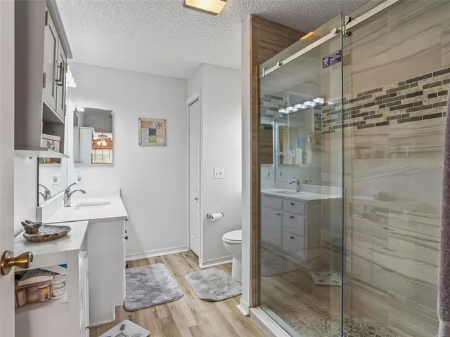 a bathroom with a shower and a sink