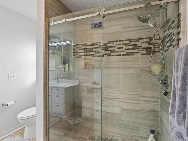 a bathroom with a shower and a toilet