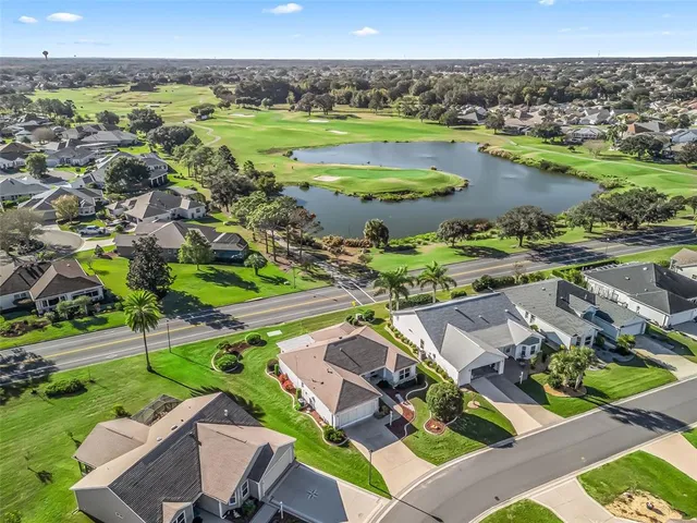 an aerial view of residential houses with outdoor space and river