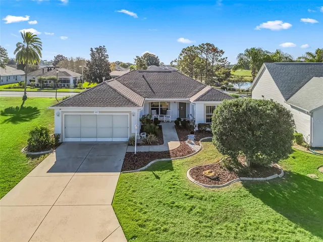 a aerial view of a house with swimming pool garden and patio