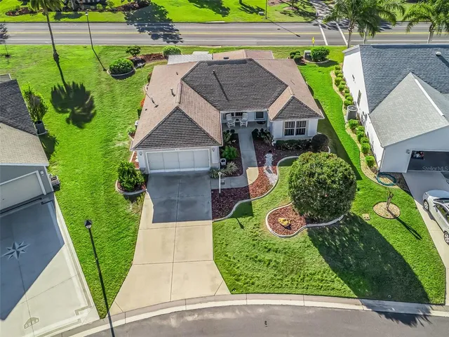 an aerial view of a house with garden space and street view