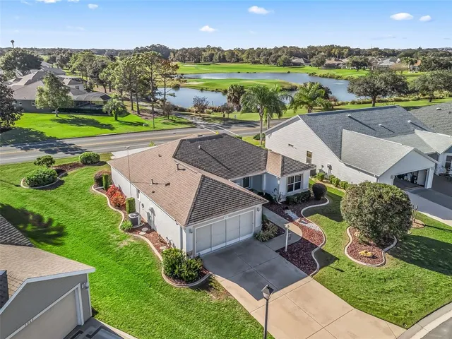 an aerial view of a house with outdoor space and lake view