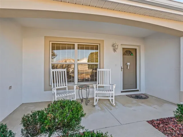 a balcony with table and chairs