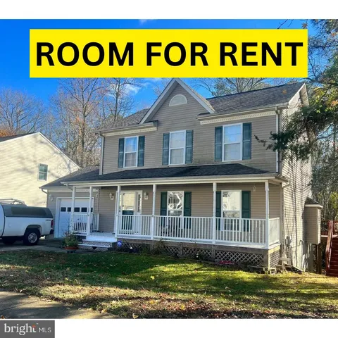a sign broad in front of a house