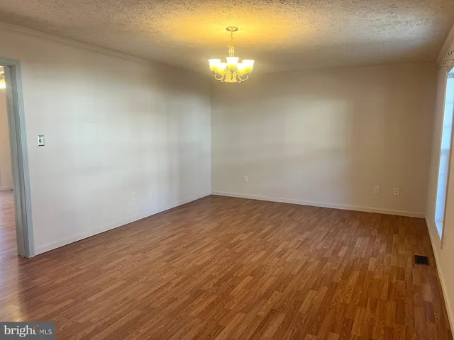 a view of an empty room and wooden floor