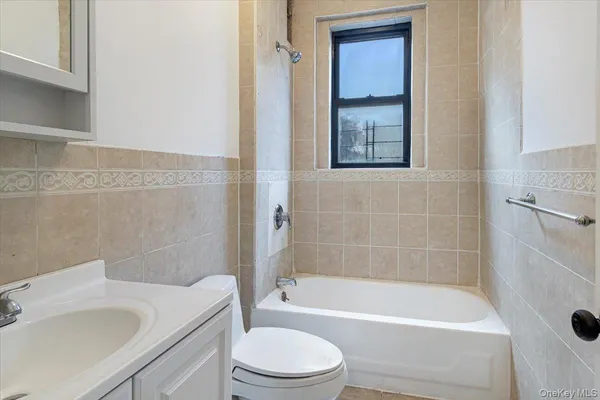 a bathroom with a sink a toilet and bathtub