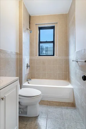 a bathroom with a toilet and a bathtub