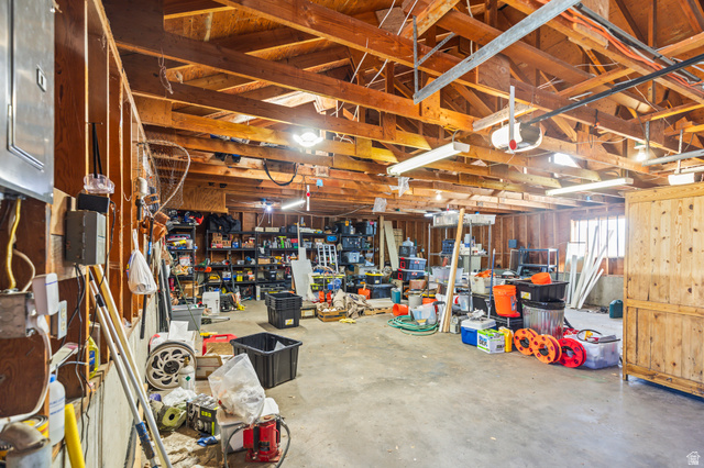 460 Omni Point Road Central Valley, UT 84754 - Photo 82 of 101 Spacious garage with exposed wood beam ceiling, concrete flooring, and ample storage potential