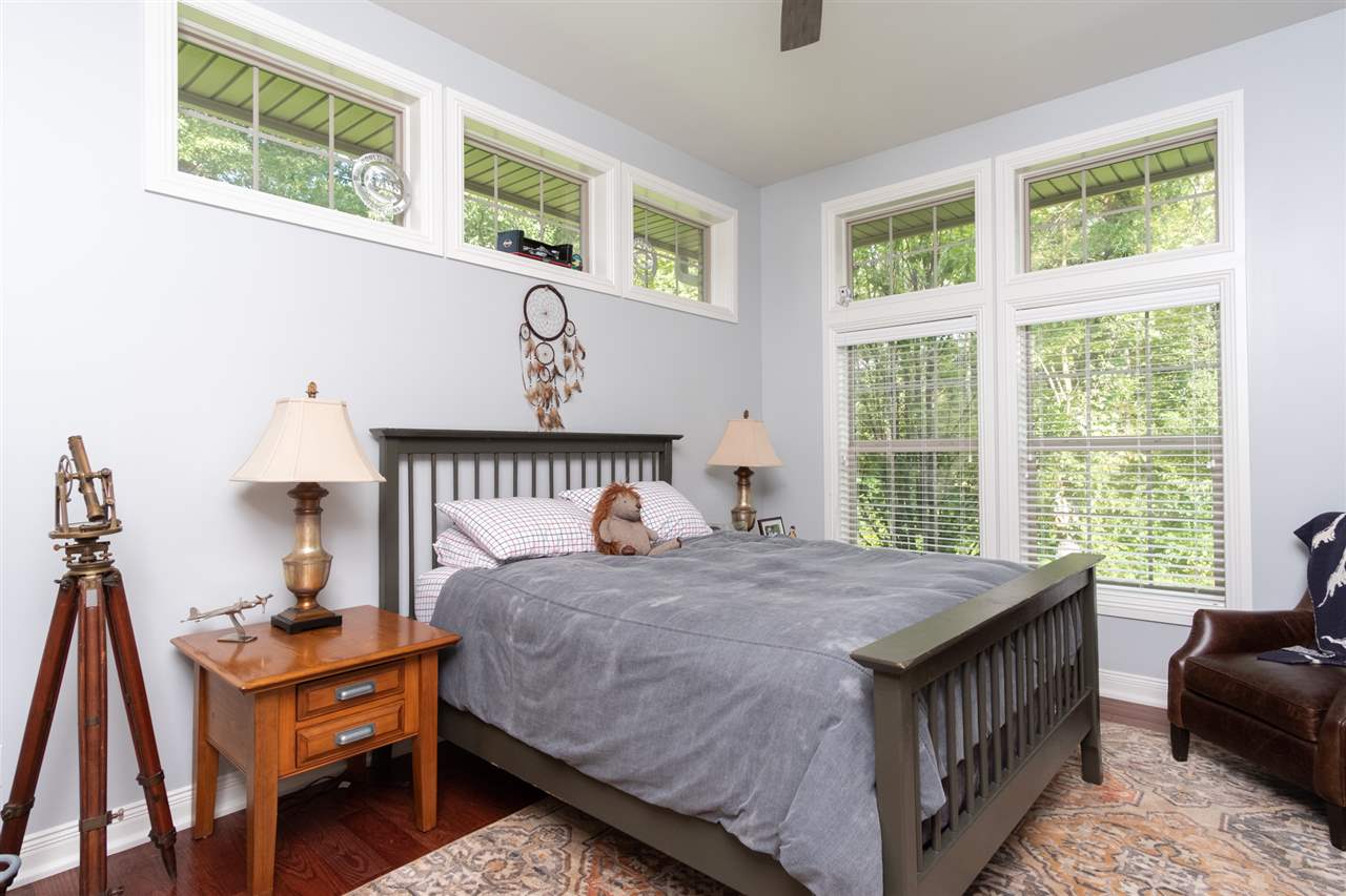 8745 Burr Oak Road Roscoe, IL 61073 - Photo 13 of 20 a bedroom with a bed a dresser and next to a window