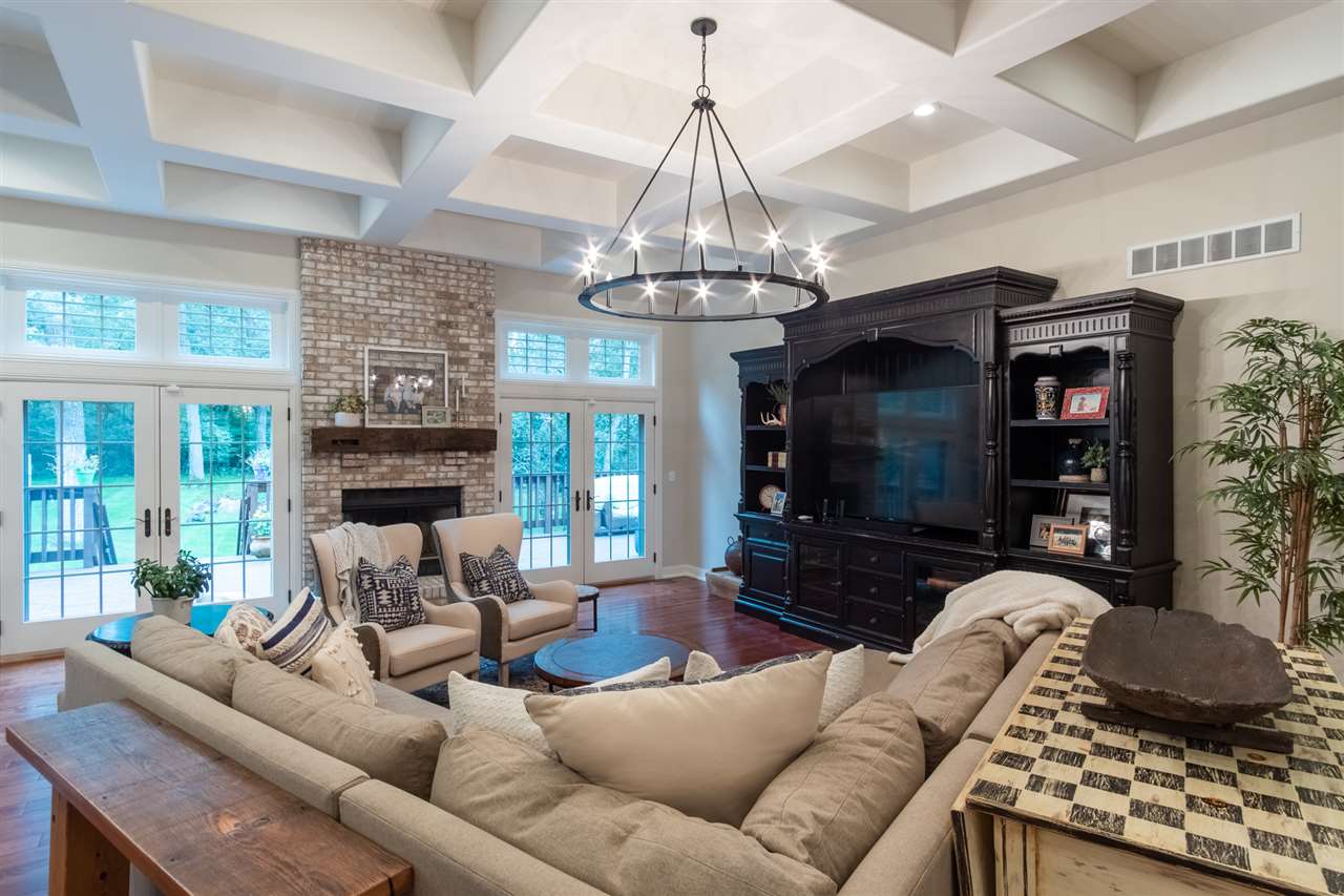8745 Burr Oak Road Roscoe, IL 61073 - Photo 2 of 20 a living room with furniture a flat screen tv and a chandelier