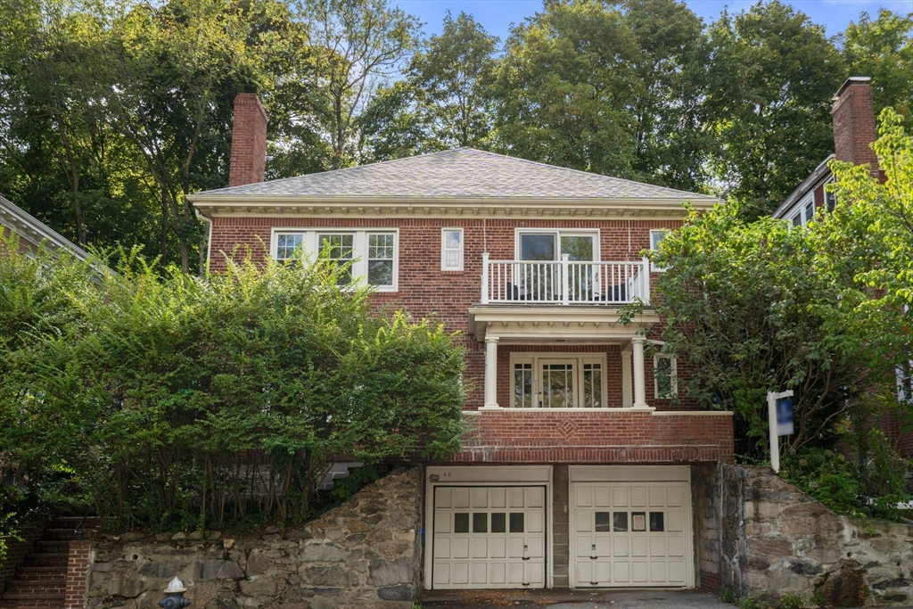 a front view of a house with a garden