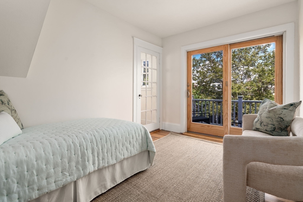 500 Washington Street, Unit 2 Brookline, MA 02445 - Photo 14 of 23 a bedroom with a bed and glass window