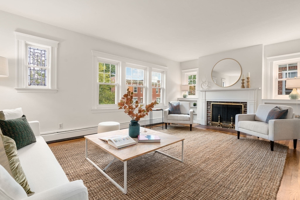 500 Washington Street, Unit 2 Brookline, MA 02445 - Photo 2 of 23 a living room with furniture a fireplace and a table