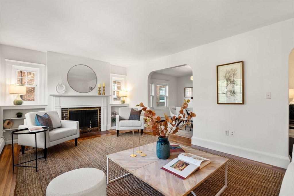 500 Washington Street, Unit 2 Brookline, MA 02445 - Photo 4 of 23 a living room with furniture a fireplace and a table