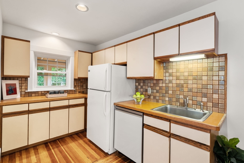500 Washington Street, Unit 2 Brookline, MA 02445 - Photo 9 of 23 a kitchen with stainless steel appliances a refrigerator and a sink