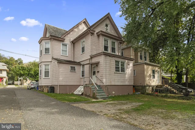 a view of backyard of house and garage