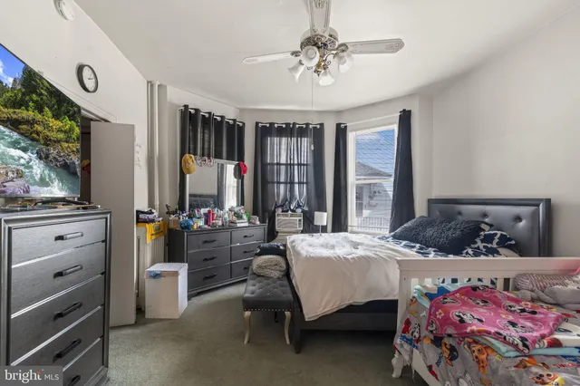 a bedroom with bed and a window