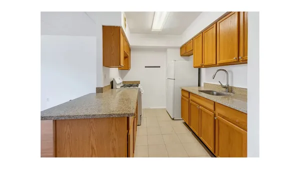 a en suite bathroom with a granite countertop sink and a mirror