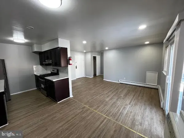 a kitchen with a refrigerator and a stove top oven