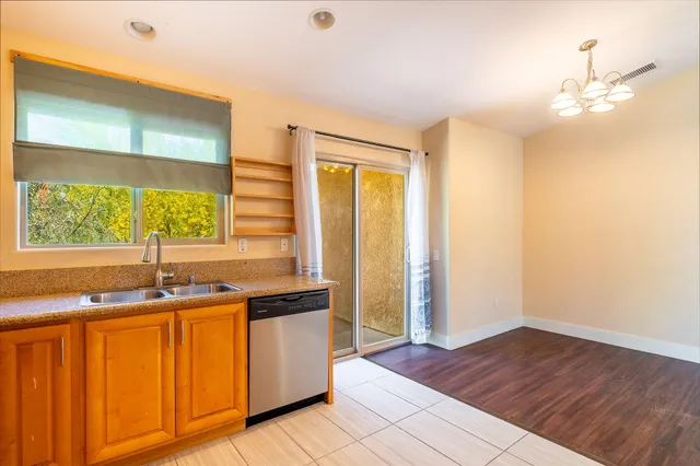 a kitchen with a sink cabinets and window