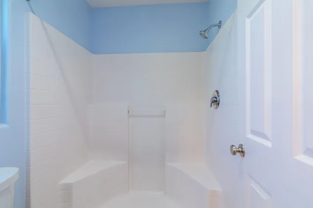 a close up of a bathtub with shower