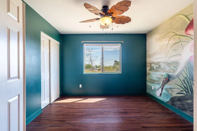 wooden floor in an empty room with a window